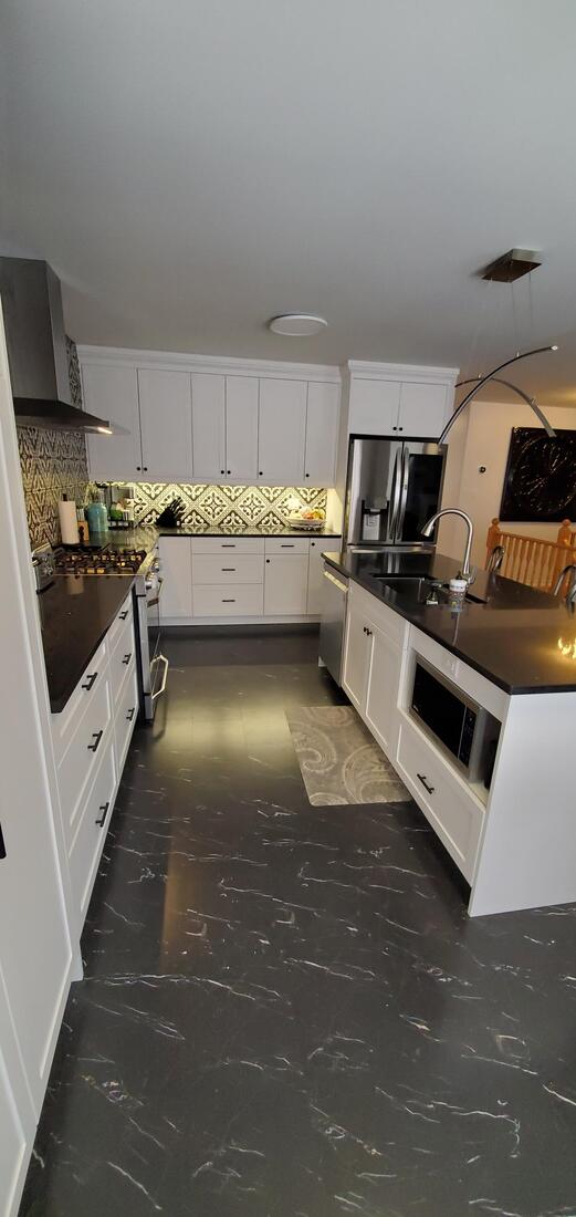 Black and white kitchen, crown molding, white shaker doors.