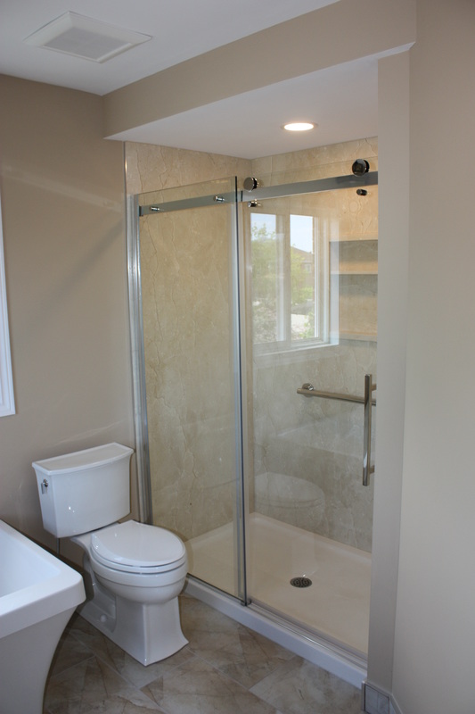 Picture Custom bathroom Designer stone panels, Siding glass shower doors, Koler toilet, tile floor