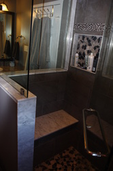 marble seat in the custom shower.
