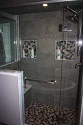 His and Her niches. Custom tiled shower with custom glass package.