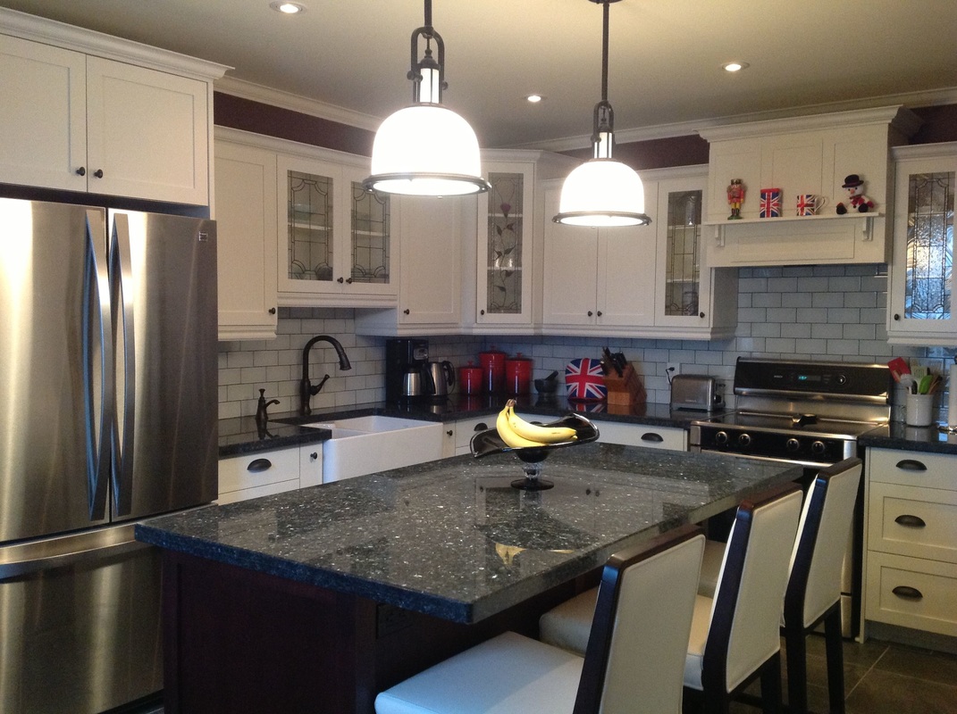Picture Custom Kitchen, white shaker door, stained glass doors, custom hood vent, satinless steel appliances, pendant lights, peal blue granite counter top, frankie farm sink, white leather counter hight chairs - stools