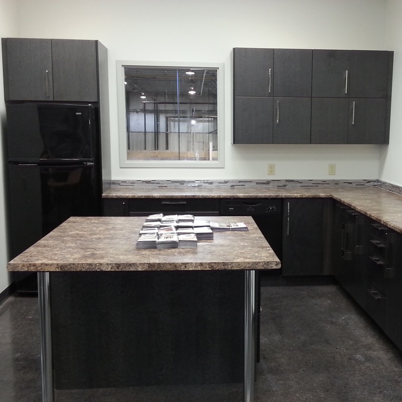 kitchen renovation in display showroom, kichen blackZambukka, counterspost form, flat veneer maple