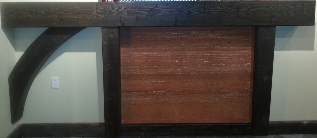 Picture Hollow timber mantel with arch, hollow timber corbels. Timber baseboards. Red travertine stone.