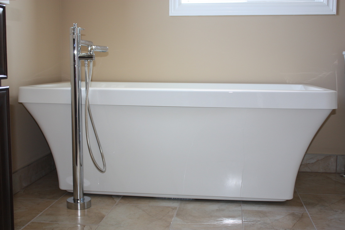 Picture Acrylic Freestanding Bath, Soaker bath, sleek white finish. Riobel Floor mount Tub Filler